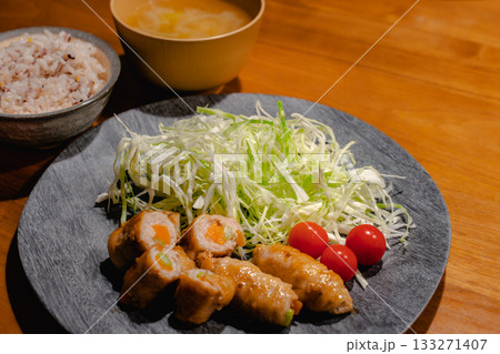 豚肉の野菜巻きと千切りキャベツ、雑穀ごはんと味噌汁の家庭的な夕食 豚肉の野菜巻きと千切りキャベツ、雑穀ごはんと味噌汁の家庭的な夕食 133271407