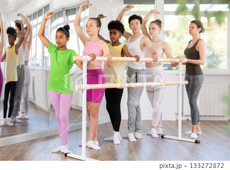 Teenage girl practicing ballet positions in dance studio 133272872