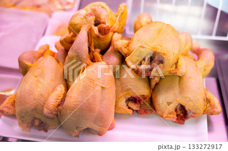 Refrigerated display case contains whole chilled chicken carcasses Refrigerated display case contains whole chilled chicken carcasses 133272917