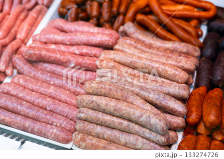 Sausages made of pork and chicken minced meat ready for grilling in meat shop Sausages made of pork and chicken minced meat ready for grilling in meat shop 133274726