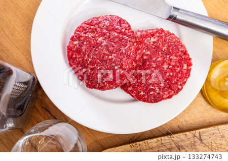 Two raw juicy beef burger cutlets are prepared for frying Two raw juicy beef burger cutlets are prepared for frying 133274743