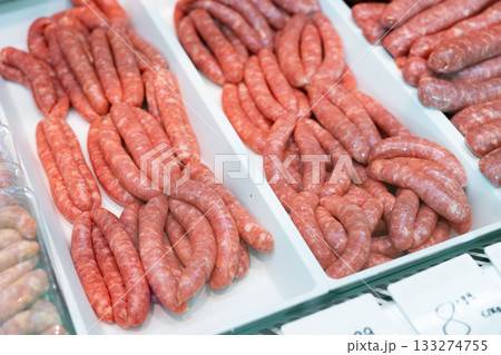 Refrigerator showcase in culinary store - various versions of butifara sausages Refrigerator showcase in culinary store - various versions of butifara sausages 133274755