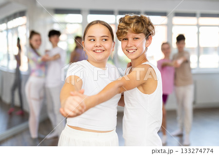 Girl dances waltz with male boy teen partner during choreography lesson 133274774