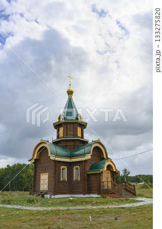 Wooden church with gilded dome and cross in the village of Lokti, Siberia, Russia, in summer Wooden church with gilded dome and cross in the village of Lokti, Siberia, Russia, in summer 133275820