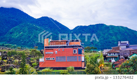 A beautiful view of a village at the foot of a mist-shrouded hill A beautiful view of a village at the foot of a mist-shrouded hill 133276482