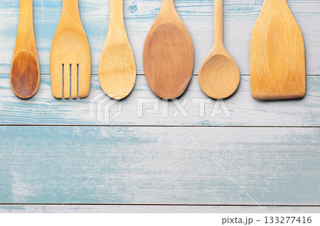 Wooden Utensils on Wooden Surface Background. File with Clipping Path. Wooden Utensils on Wooden Surface Background. File with Clipping Path. 133277416