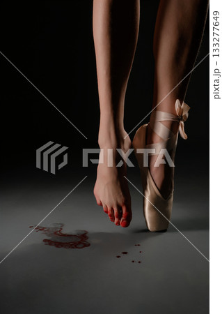 Dancer's bare foot on stage with pointe shoe and red marks on the floor Dancer's bare foot on stage with pointe shoe and red marks on the floor 133277649