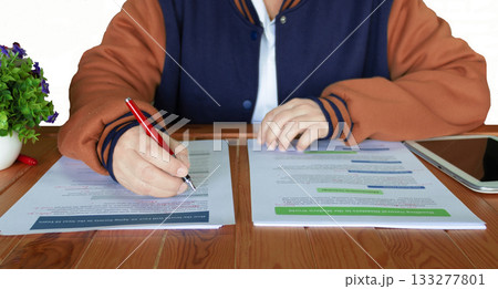 proofreading worksheet on wooden table 133277801