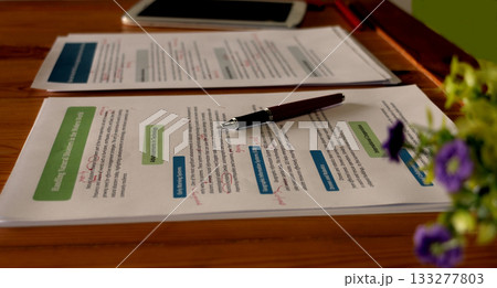 proofreading worksheet on wooden table 133277803