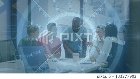 Discussing six professionals leaning over documents in office, with laptop, coffee and tech overlay 133277902