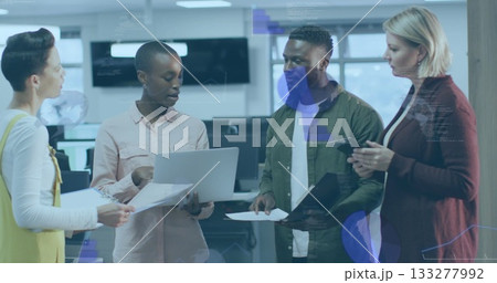 Four business professionals collaborating in office with laptop, printed documents and smartphone Four business professionals collaborating in office with laptop, printed documents and smartphone 133277992