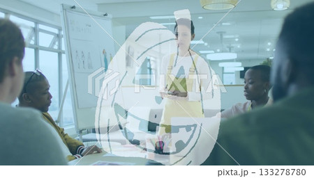 Presenter wearing yellow apron holding tablet with stylus in office with whiteboard sketches Presenter wearing yellow apron holding tablet with stylus in office with whiteboard sketches 133278780