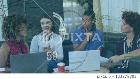 Gesturing project lead presenting floating data charts at office lounge, with laptops and documents 133278803