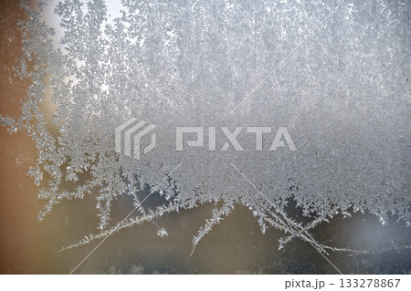 Frosted Glass With Intricate Ice Crystals Creating Delicate Winter Pattern Across Surface 133278867