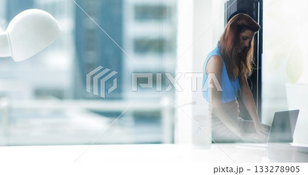 Typing Hispanic woman in business attire at desk by window on laptop, desk lamp, copy space Typing Hispanic woman in business attire at desk by window on laptop, desk lamp, copy space 133278905