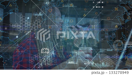 Speaking bearded man with dreadlocks and glasses using smartphone at cafe table, digital network 133278949