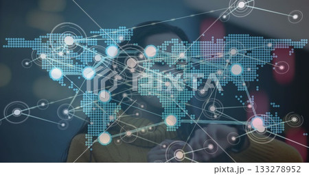 Asian woman in mustard sweater and visor interacting with digital map in lab, with glowing nodes Asian woman in mustard sweater and visor interacting with digital map in lab, with glowing nodes 133278952