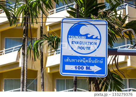 Evacuation route arrow beach direction sign signs Patong Phuket Thailand. 133279376