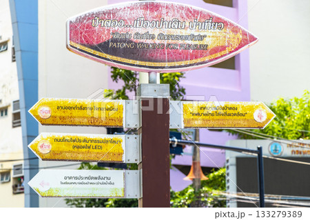 Surfboard and arrow beach direction sign signs Patong Phuket Thailand. 133279389