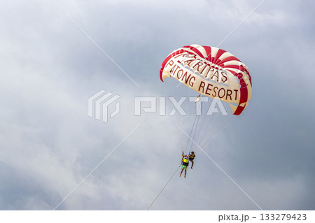 Patong Beach Phuket with parachute sport and parasailing activity Thailand. 133279423