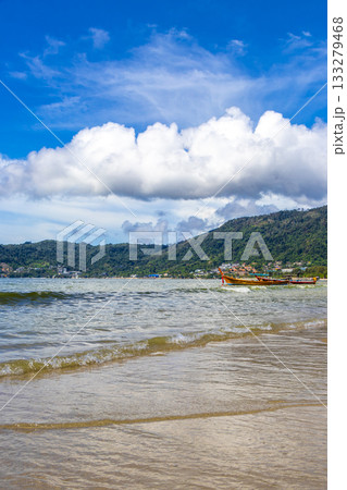 Patong Beach Phuket with promenade boats turquoise blue water Thailand. 133279468