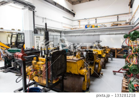 Flat design workshop is featuring yellow road rollers in parallel rows with green hose cart 133281218