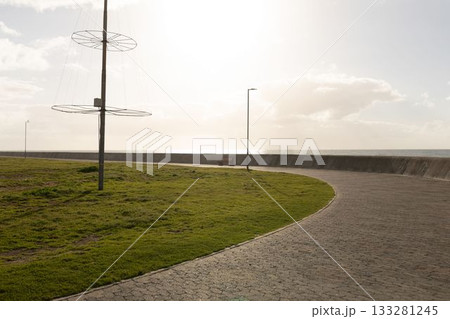 Front view of lampposts on the coast line against blue sky 133281245