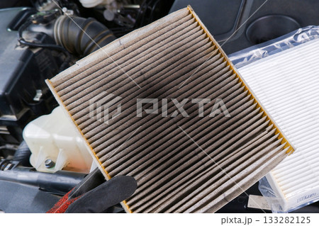 Old, clogged air filter removed from air system. Old, clogged air filter removed from air system. 133282125