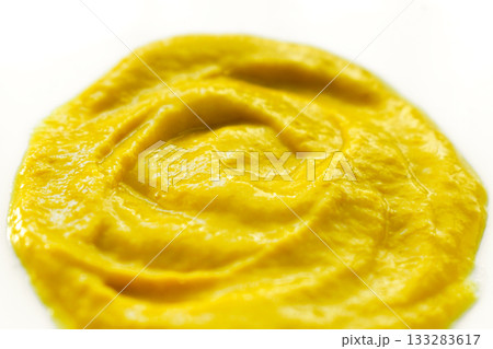 Yellow mustard on a white plate. Yellow mustard on a white plate. 133283617