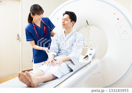 CTスキャンを受ける男性と放射線技師　撮影協力：学校法人電波学園　東京電子専門学校 133283955
