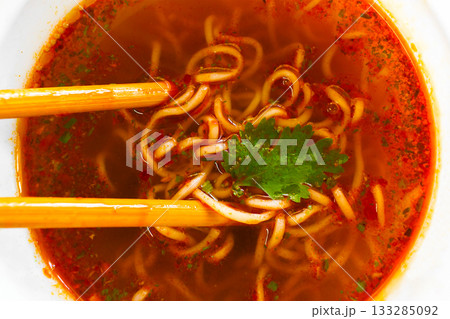 Spicy instant noodles with chopsticks in a plastic cup. 133285092