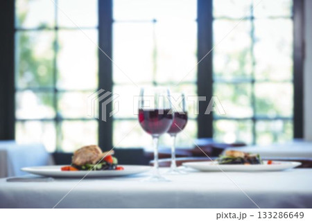 Wineglasses by lamb chop in plate on table Wineglasses by lamb chop in plate on table 133286649