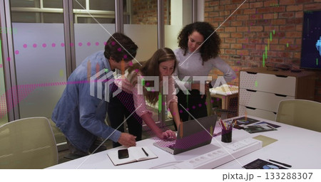 Group of three colleagues collaborating in office meeting area, analyzing charts on laptop Group of three colleagues collaborating in office meeting area, analyzing charts on laptop 133288307
