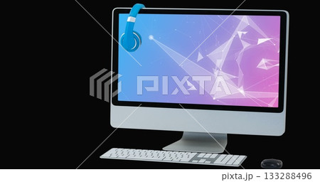 Monitor displaying gradient network on studio desk, with blue headphones, keyboard and mouse 133288496