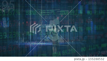 Monitoring businesswoman in suit and heels manipulating holographic data panels in office at night 133288532