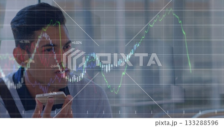 Speaking professional in blazer holding phone at desk with glass divider and charts, copy space Speaking professional in blazer holding phone at desk with glass divider and charts, copy space 133288596