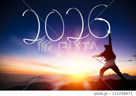 Silhouette of  young man  on the mountain while celebrating new year of 2026 at dusk time 133288671