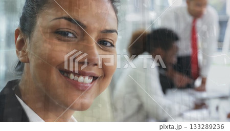 Smiling woman in blazer leading discussion at office, with laptop, data overlay, copy space 133289236