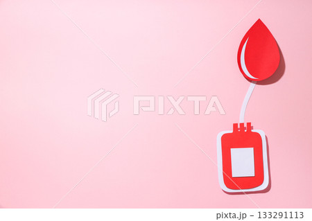 Red paper blood drop and container design on pink background 133291113