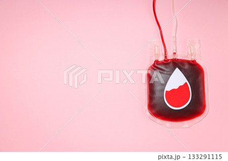 Blood donation bag with red liquid against a pink backdrop Blood donation bag with red liquid against a pink backdrop 133291115