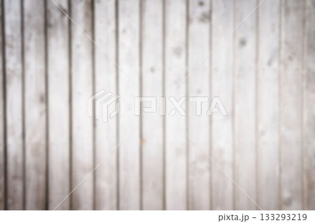 Vertical wooden plank wall is displaying weathered grain in flat design, showing subtle knots 133293219