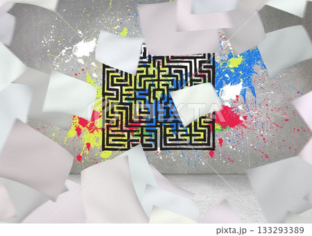 Papers in front of grey wall with maze and splashes 133293389