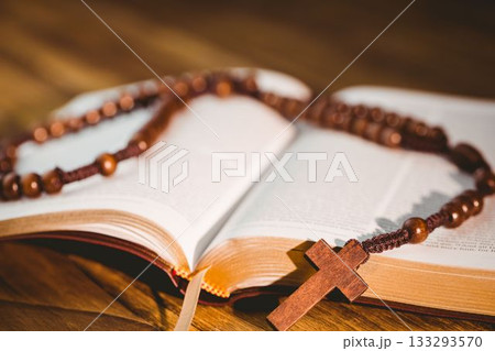 Rosary beads kept on open bible 133293570