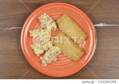 Fish Filets and French Salad 133294199