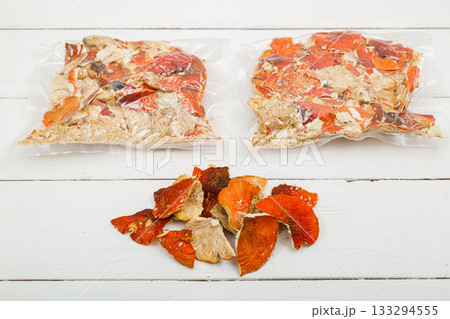 Dried fly agaric in a transparent package on a white background. 133294555