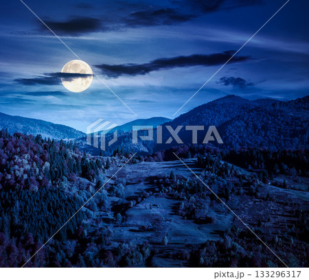 rural area in mountains autumn landscape at night. beautiful countryside scenery with rolling hills under dark sky in full moon light. backdrop for fiction art or mystery concepts rural area in mountains autumn landscape at night. beautiful countryside scenery with rolling hills under dark sky in full moon light. backdrop for fiction art or mystery concepts 133296317
