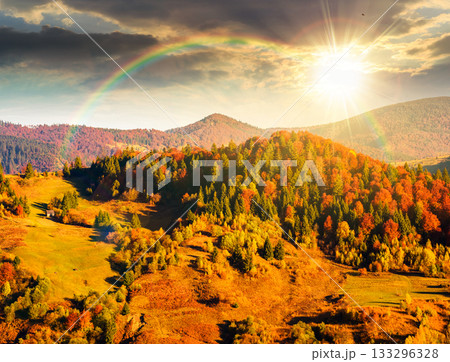 rural area in mountains autumn landscape at sunset. beautiful countryside scenery with rolling hills under blue sky in evening light. leadership corporate wallpaper under the rainbow rural area in mountains autumn landscape at sunset. beautiful countryside scenery with rolling hills under blue sky in evening light. leadership corporate wallpaper under the rainbow 133296328