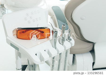 Dental instruments and safety glasses on the module, there are no people in the dental clinic Dental instruments and safety glasses on the module, there are no people in the dental clinic 133296581
