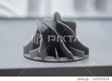 Prototype turbine compressor wheel printed on a 3D printer. Small model turbine rotor created on a 3D printer from molten plastic. 3D printing technology. New modern additive FDM printing technologies Prototype turbine compressor wheel printed on a 3D printer. Small model turbine rotor created on a 3D printer from molten plastic. 3D printing technology. New modern additive FDM printing technologies 133297019