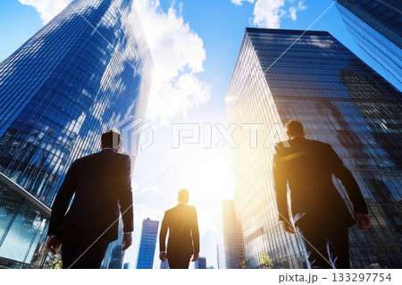 Three men walking in front of a tall building Three men walking in front of a tall building 133297754